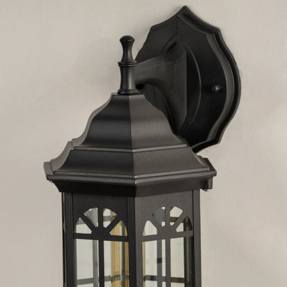 Closeup of black outdoor lantern showing the clear glass panes and classic decorative metal frame ideal for traditional outdoor porch and patio lighting.
