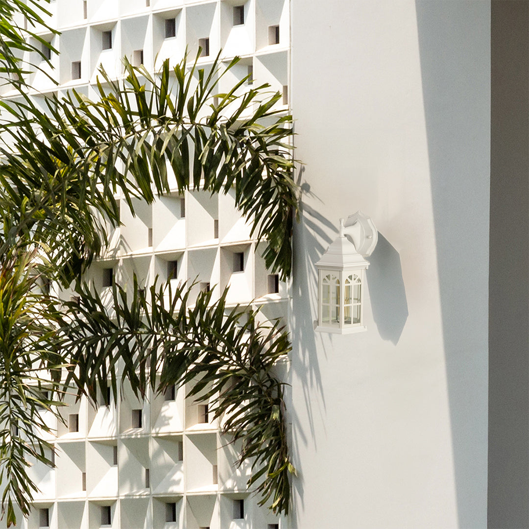 White outdoor lantern with the light off displayed on a clean exterior wall highlighting its classic window style glass panels and bright modern outdoor design.