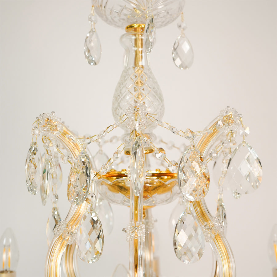 Closeup image of candelabra chandelier for luxury living room decor styling with polished finish.