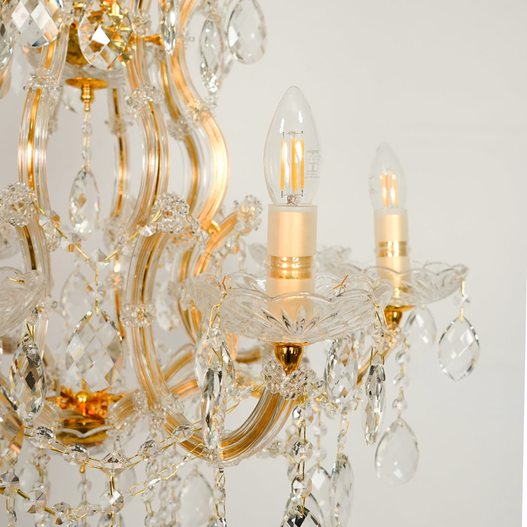Closeup image of large candelabra chandelier for luxury living room decor styling with polished finish.
