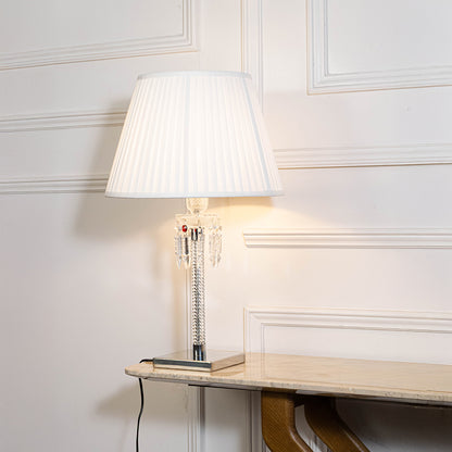 Classic table lamp in white finish with fabric shade for bedside or living room ambient lighting decor placement white background.