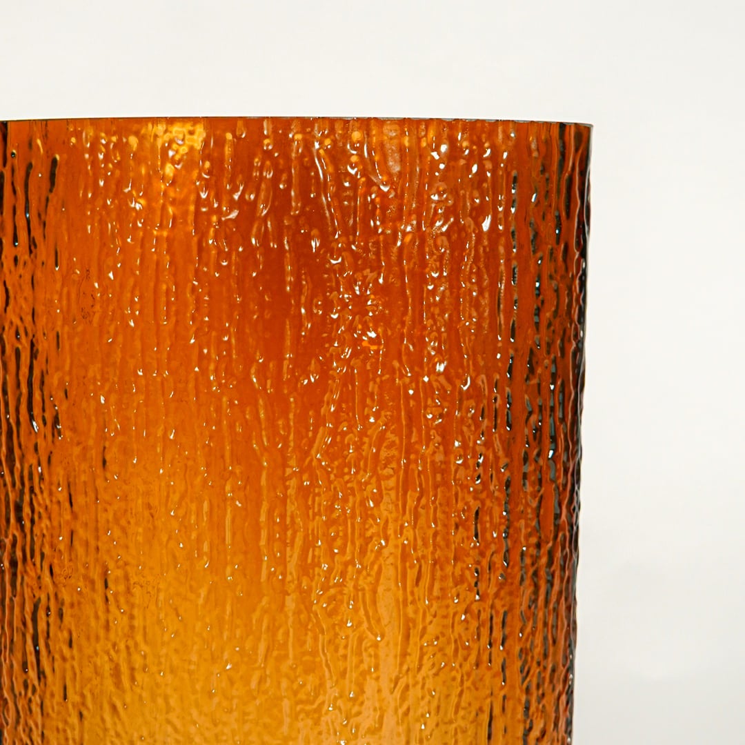 Close up view amber decorative glass vase showing rich color texture luxury glass accent piece for console shelf styling home.