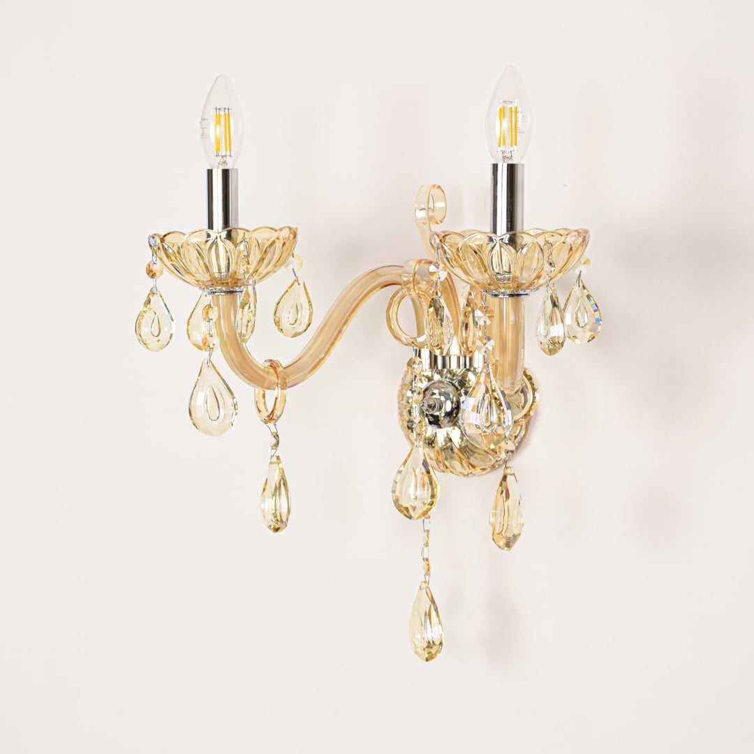 Golden crystal wall light displayed on white background ideal for classic warm interior wall styling.