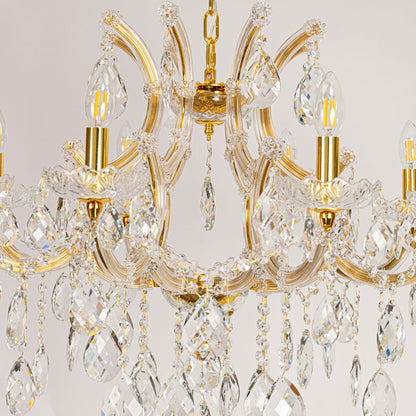 Closeup of gold crystal chandelier arms and hanging drops showing fine detailing for premium home lighting.