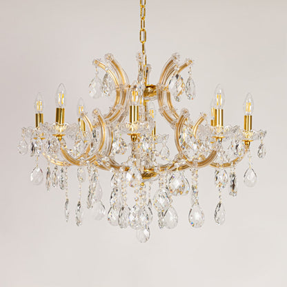 Gold crystal chandelier with ornate crystal arms shown on a white background for elegant home decor inspiration.