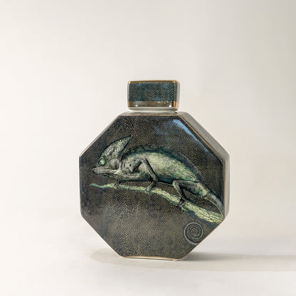Green ceramic decorative jar with textured glaze and geometric form for elegant tabletop styling and home decor.