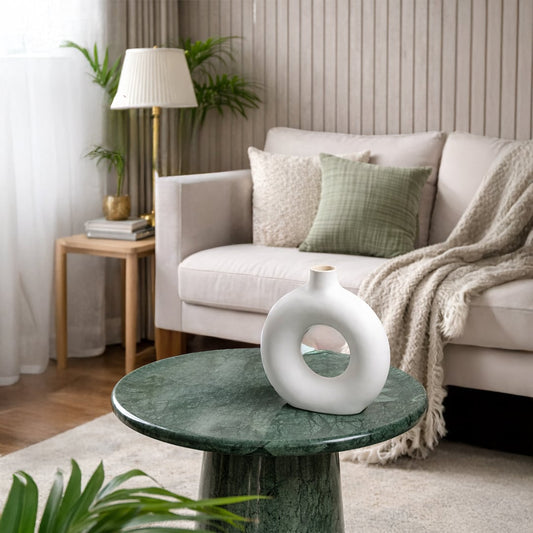 White ceramic ring vase styled on a living room table adding artistic charm to modern home decor settings.