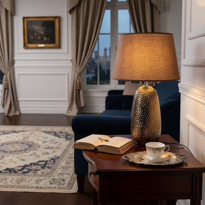 Textured table lamp styled beside sofa and tableware creating cozy ambient lighting and refined living room Decor mood.