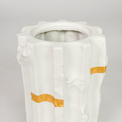 White ceramic decorative vase closeup with gold accent modern flower vase for shelf console living room decor styling.