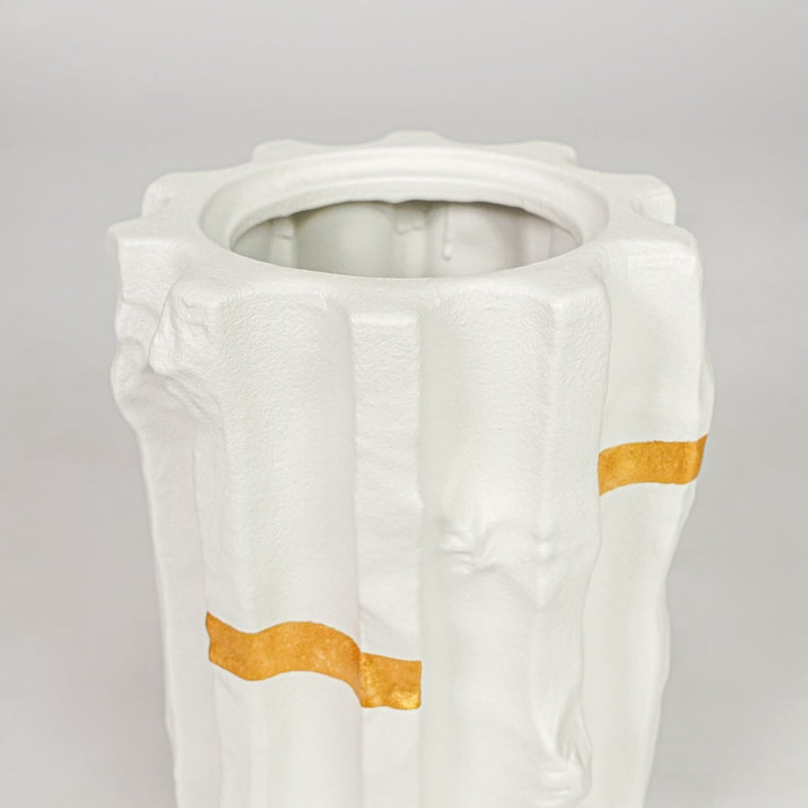 White ceramic decorative vase closeup with gold accent modern flower vase for shelf console living room decor styling.