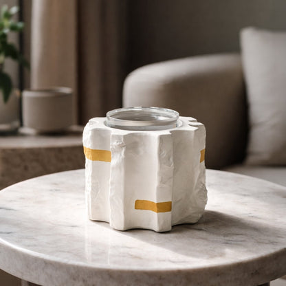 White ceramic vase with gold accents placed on living room console table adding modern decorative elegance to home interior.