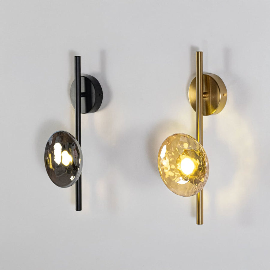 Modern black and gold metal wall light with textured glass shade for elegant luxury interior wall decor.