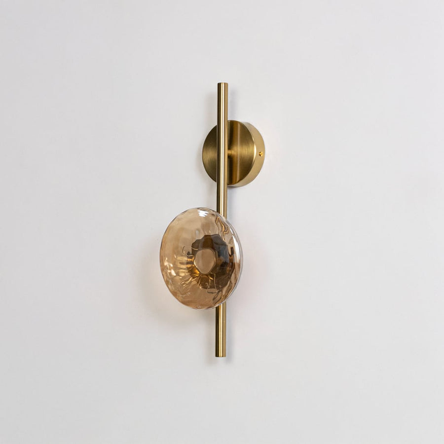 Gold metal wall light on white background with smoked textured glass shade for stylish interior wall decor.