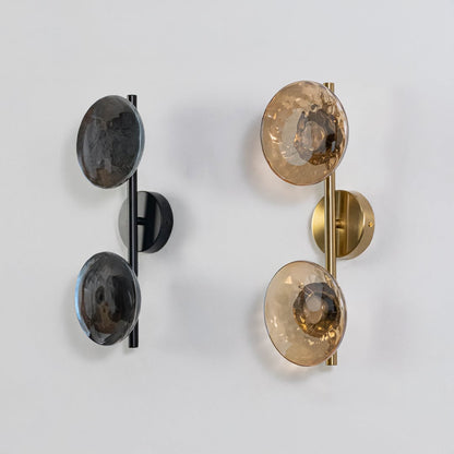 Gold double wall lights with amber textured glass globes shown on a bright white background with lights off for clarity.