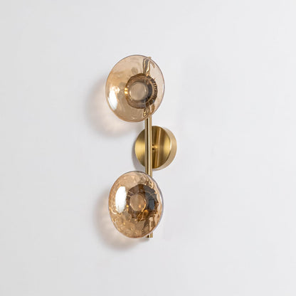 Gold double wall light with amber textured glass globes shown on a plain white background with lights off for detail.