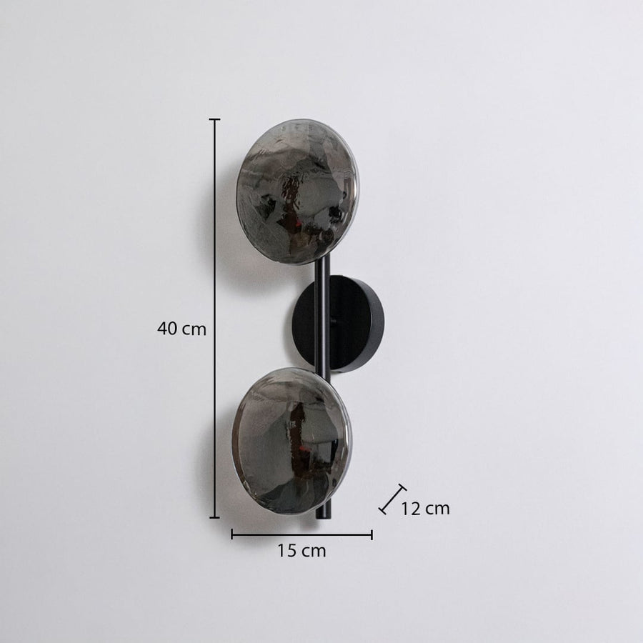 Modern black metal wall sconce with dual smoked glass globes showing 40cm height 15cm width 12cm depth on white background.
