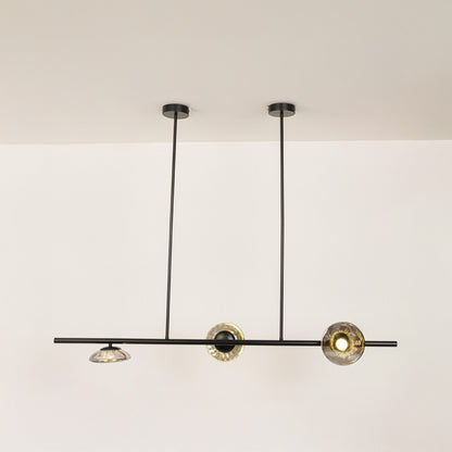 Black metal linear chandelier with circular glass accents designed for sleek modern ceiling lighting in contemporary interiors.