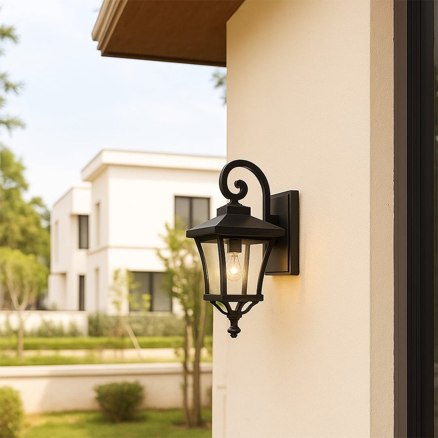 Outdoor lantern wall light illuminating a modern home exterior.