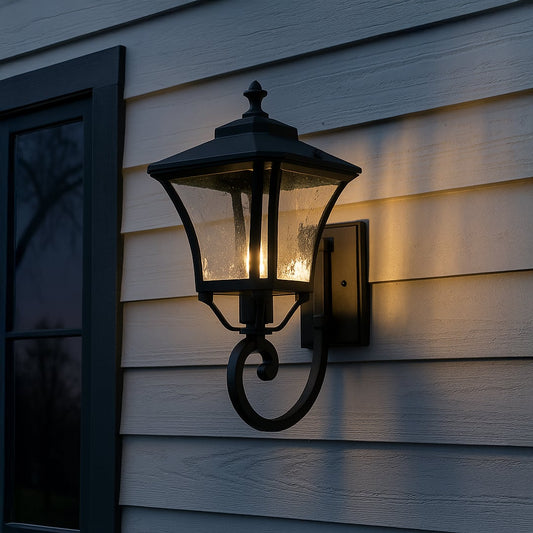 Elegant black metal outdoor wall lantern with textured glass creating warm ambient lighting for entrance and porch decor.