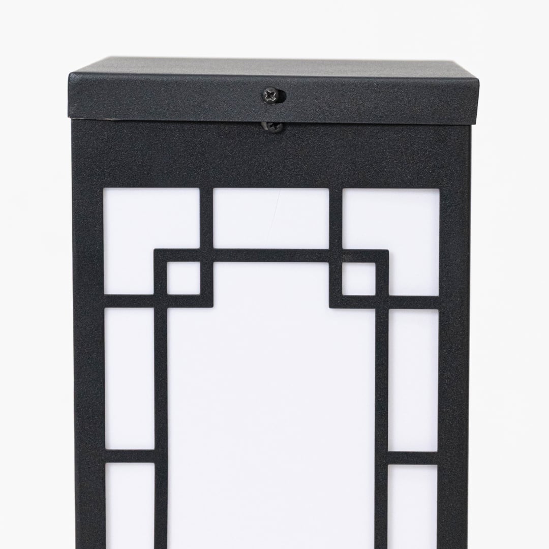 Closeup of black outdoor wall lantern showing geometric frame frosted glass panel and clean contemporary exterior design.