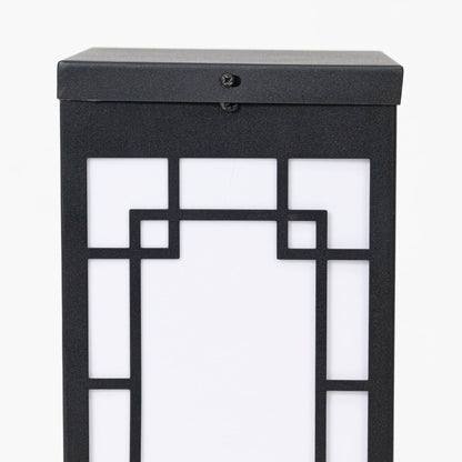 Closeup of black outdoor wall lantern showing geometric frame frosted glass panel and clean contemporary exterior design.