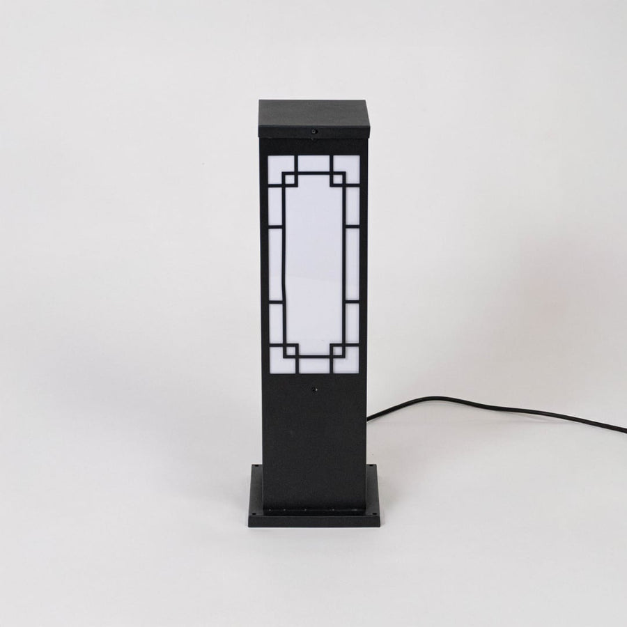 Sleek black pillar light with frosted glass shade displayed off on white background for contemporary look.