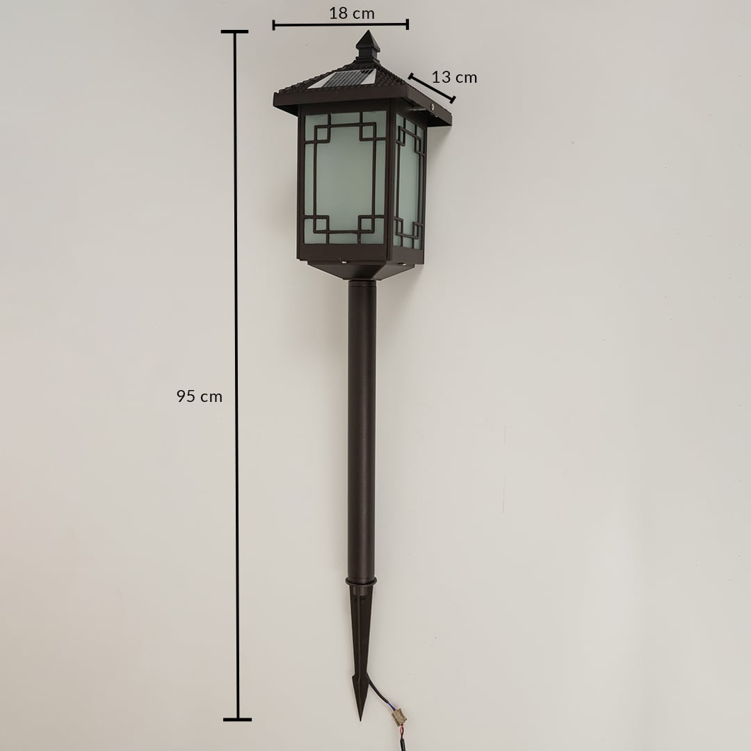 Brown solar garden spike lantern with frosted patterned glass shown with 95 cm height 18 cm width and 13 cm depth providing accurate outdoor installation sizing.