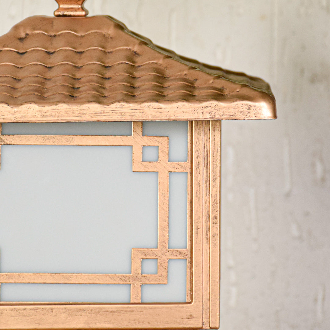 Close view of outdoor pillar light with wooden finish and pagoda style roof showcasing detailed traditional exterior lighting design.