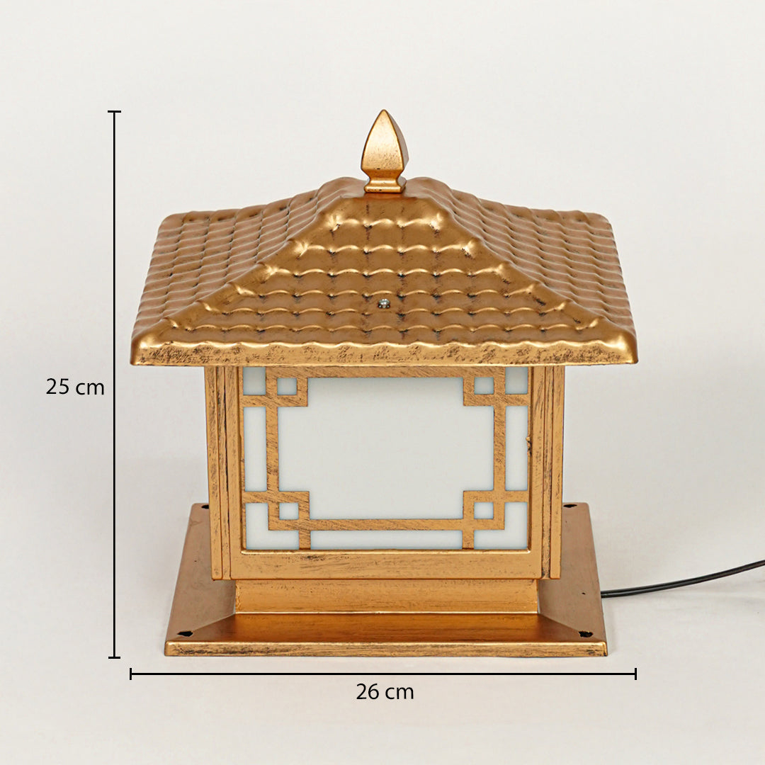 Traditional outdoor pillar lamp with gold finish and geometric frame design on neutral background 25 cm height 26 cm width perfect for garden or gate lighting.