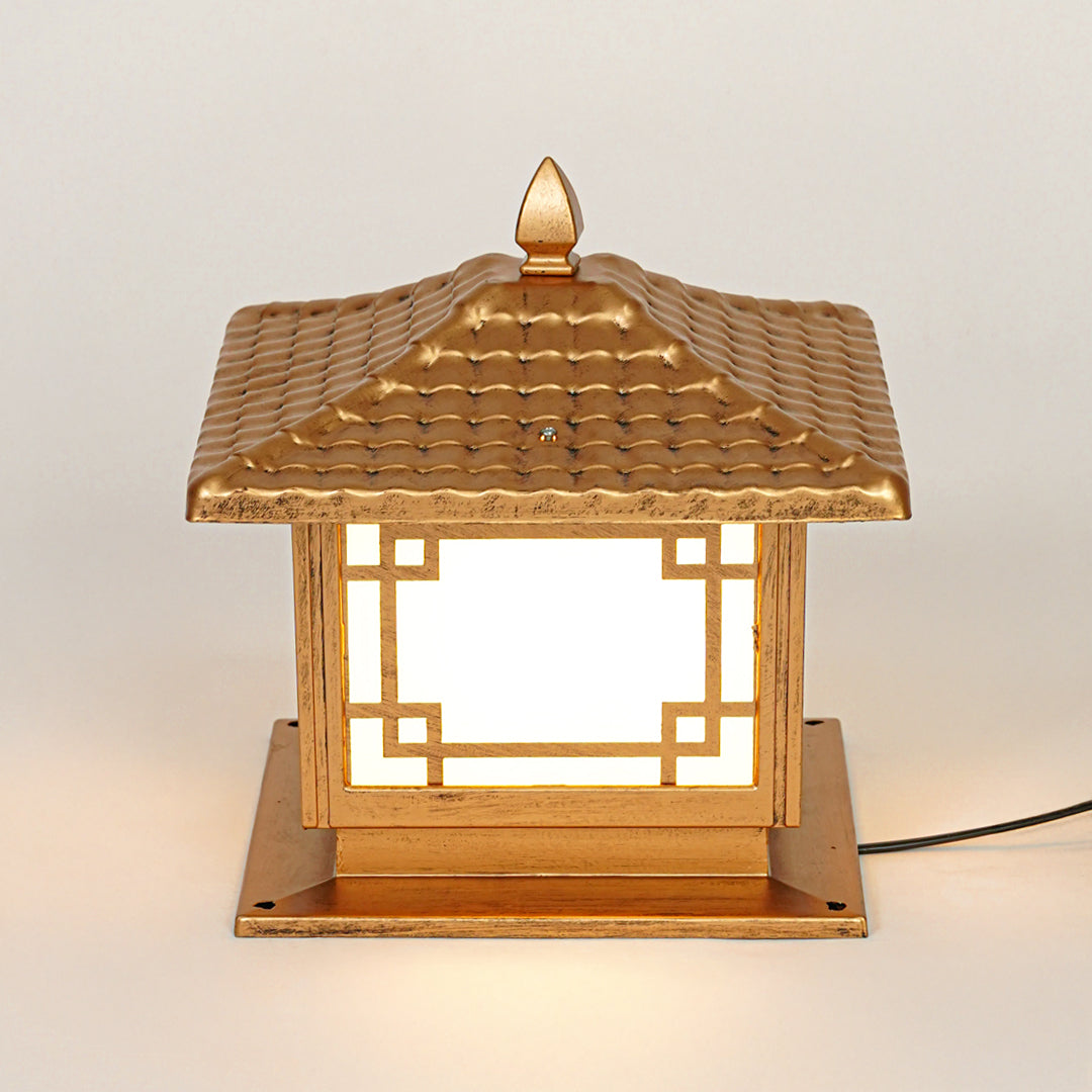 Traditional outdoor pillar light with bronze metal finish and glowing glass panels on neutral background ideal for vintage style outdoor lighting.

