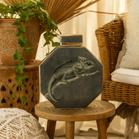 Dark green octagon ceramic jar displayed on a woven stool adding rustic earthy charm suitable for natural home décor themes and warm interior styling accents.