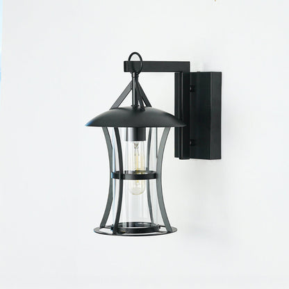 Classic black outdoor wall lantern with clear glass panels mounted on neutral wall ideal for patio or exterior home lighting decor.