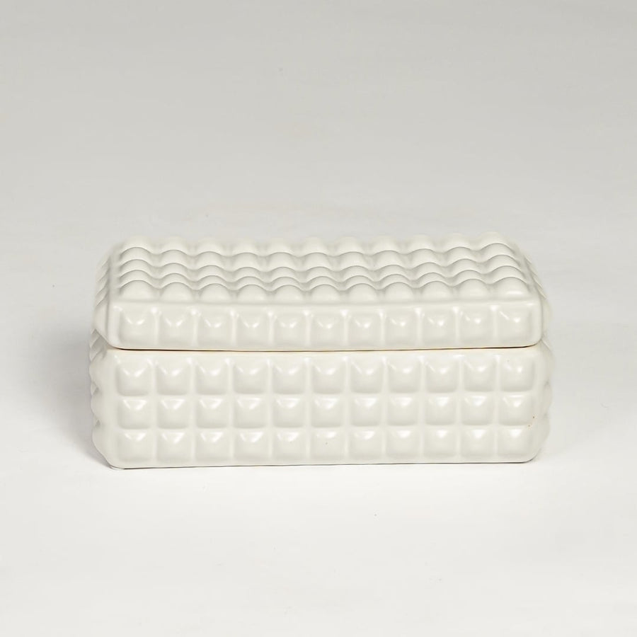 White ceramic textured storage box with geometric pattern and fitted lid isolated on white background for elegant decor use.
