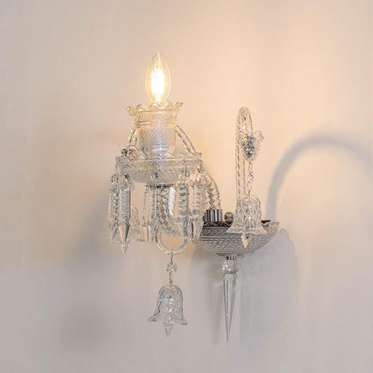 Modern crystal wall light in chrome finish with candle bulbs for bedroom or living decor lighting white background.