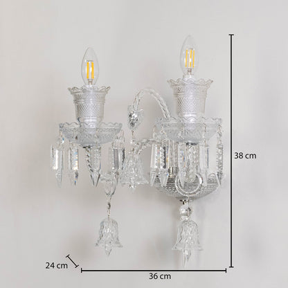 Double arm crystal wall light with ornate glass shades and crystal accents size 24cm height 38cm width 36cm depth displayed with measurements.