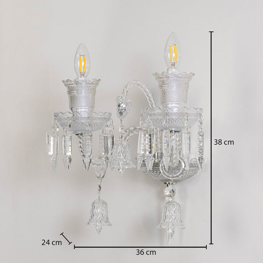 Double arm crystal wall light with ornate glass shades and crystal accents size 24cm height 38cm width 36cm depth displayed with measurements.