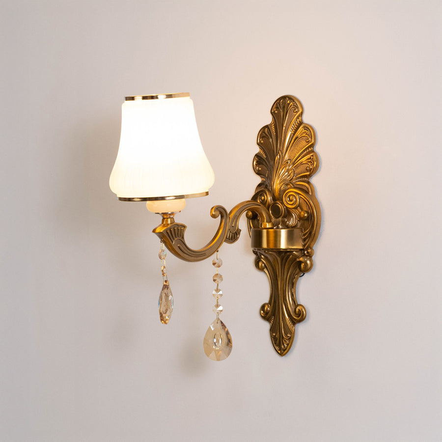 Classic metal wall light in gold finish with fabric shade and crystals for bedroom or living decor lighting white background.
