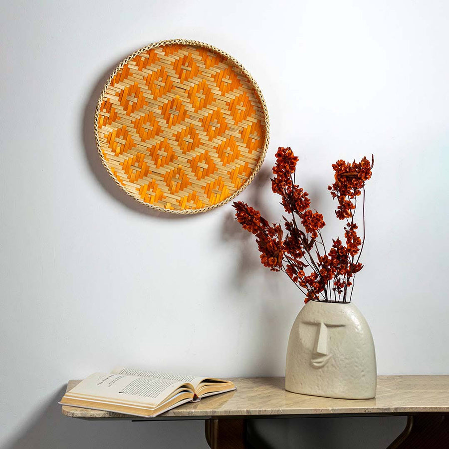Handcrafted orange and natural seagrass wall basket for living room shelf and modern boho home décor styling.