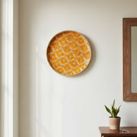 Round wall decor in warm yellow tone mounted on white wall enhancing bright cheerful ambiance and modern home interior styling.