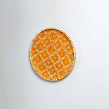 Natural woven orange and beige seagrass wall basket for living room boho décor on white background image.