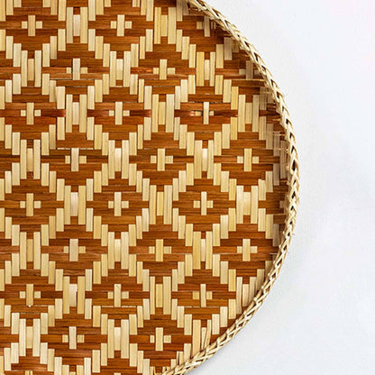 Closeup of handcrafted brown and natural seagrass wall basket with geometric woven pattern for artisan home décor.