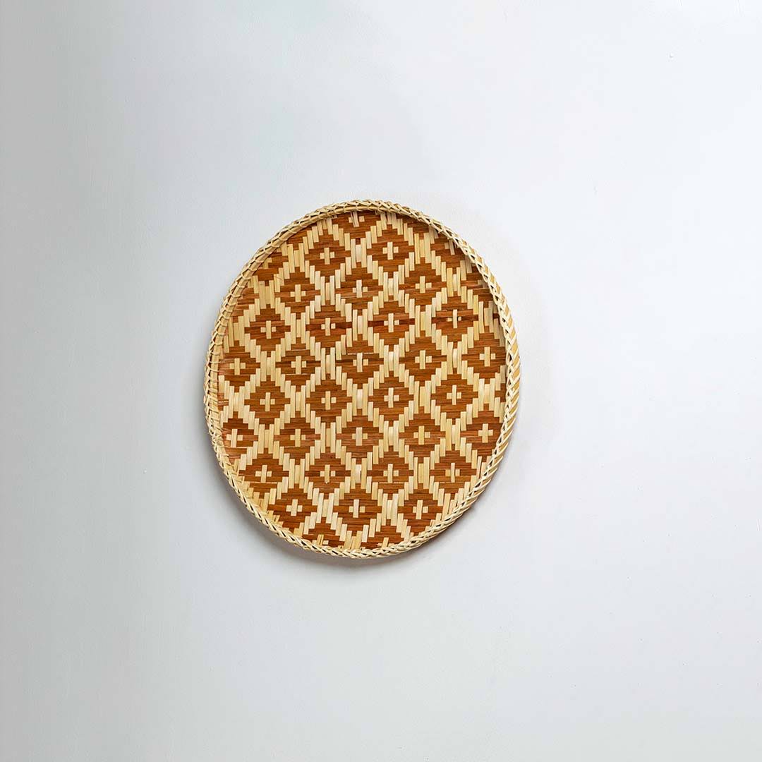 Natural woven brown and beige seagrass wall basket for living room boho décor on white background image.