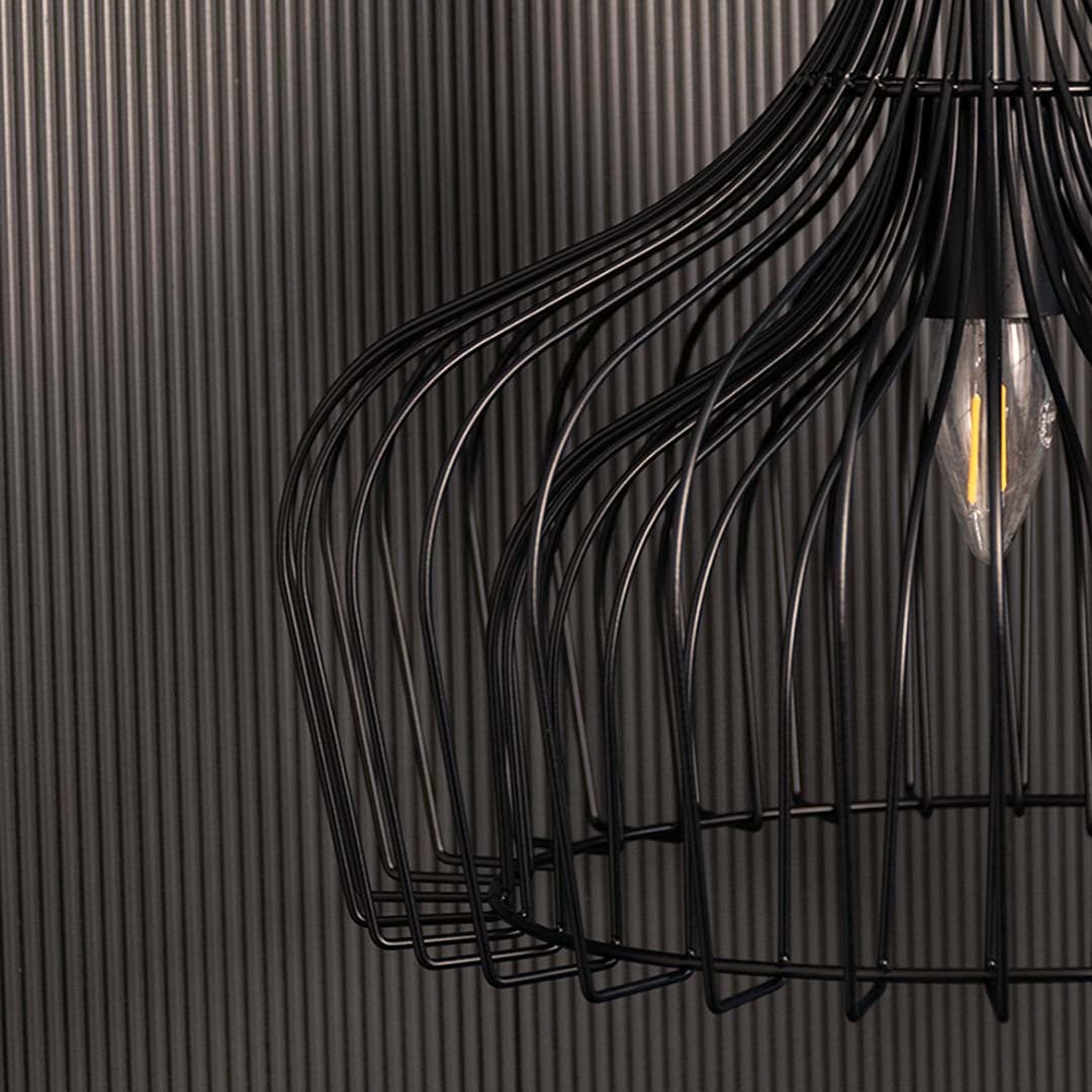 Detailed closeup of the black wire pendant lamp showing the intricate curved metal strands and visible bulb for an artistic modern look.