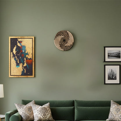 Handwoven round wall basket displayed above a green sofa adding natural texture and artisanal warmth to a modern living room wall.