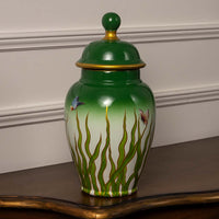 Elegant handcrafted ceramic decor jar with green gradient and butterfly design ideal for modern interior styling.