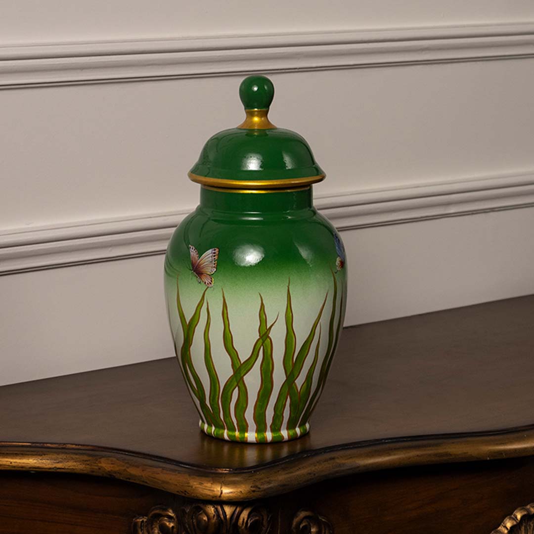 Elegant green and white ceramic jar with golden rim and butterfly artwork perfect for modern home interiors.