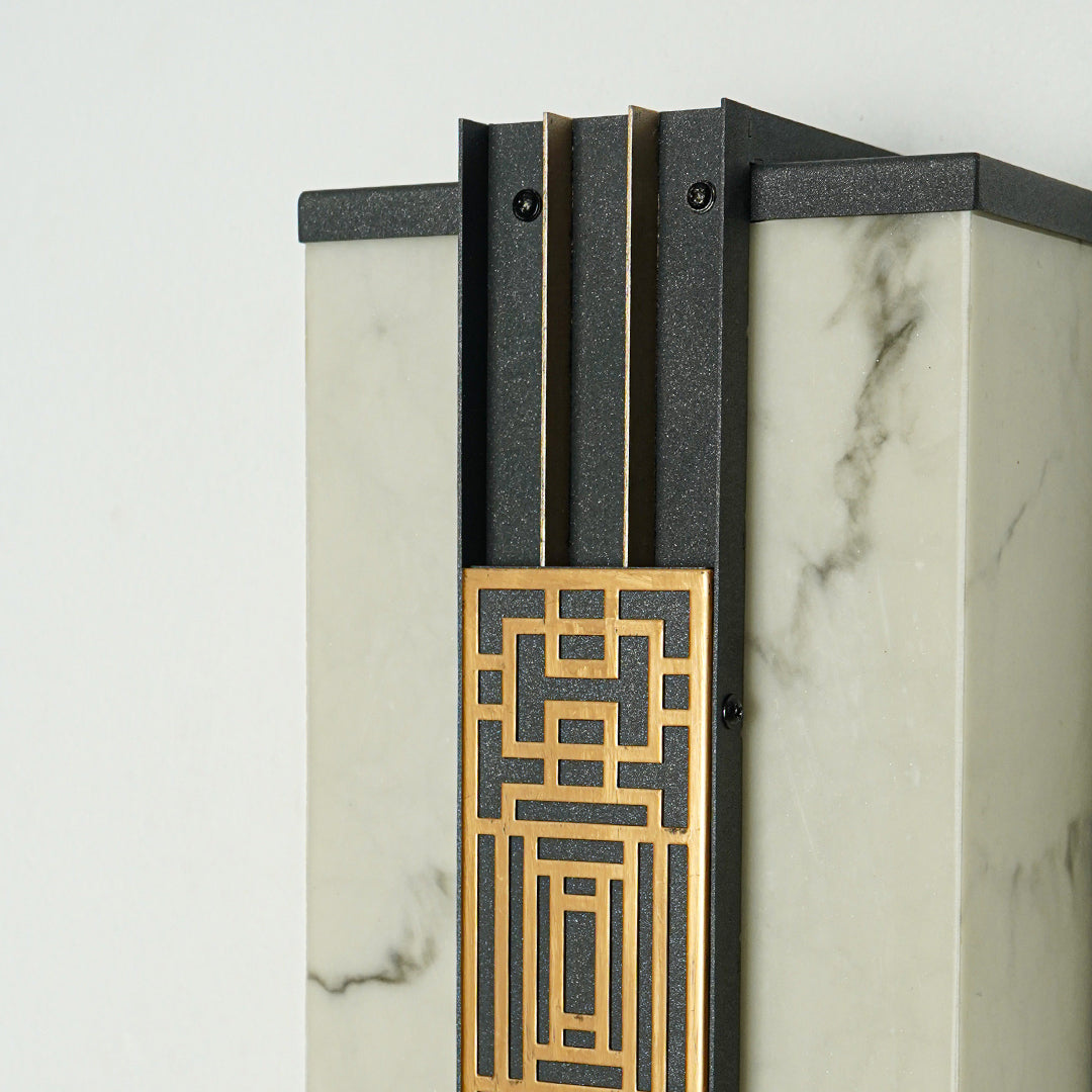 Close view of outdoor wall light with geometric gold detailing and glass panel showcasing premium modern exterior lighting design.