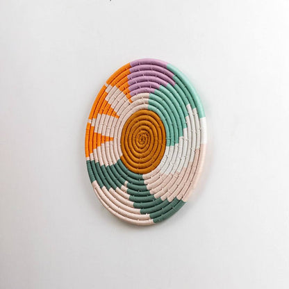 Round handcrafted multicolor seagrass wall basket for living room hallway and boho décor on white background image.