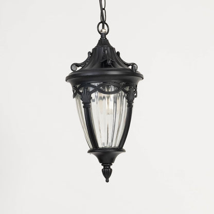 Unlit black metal globe hanging light fixture with decorative circular pattern cage isolated against a plain white background.