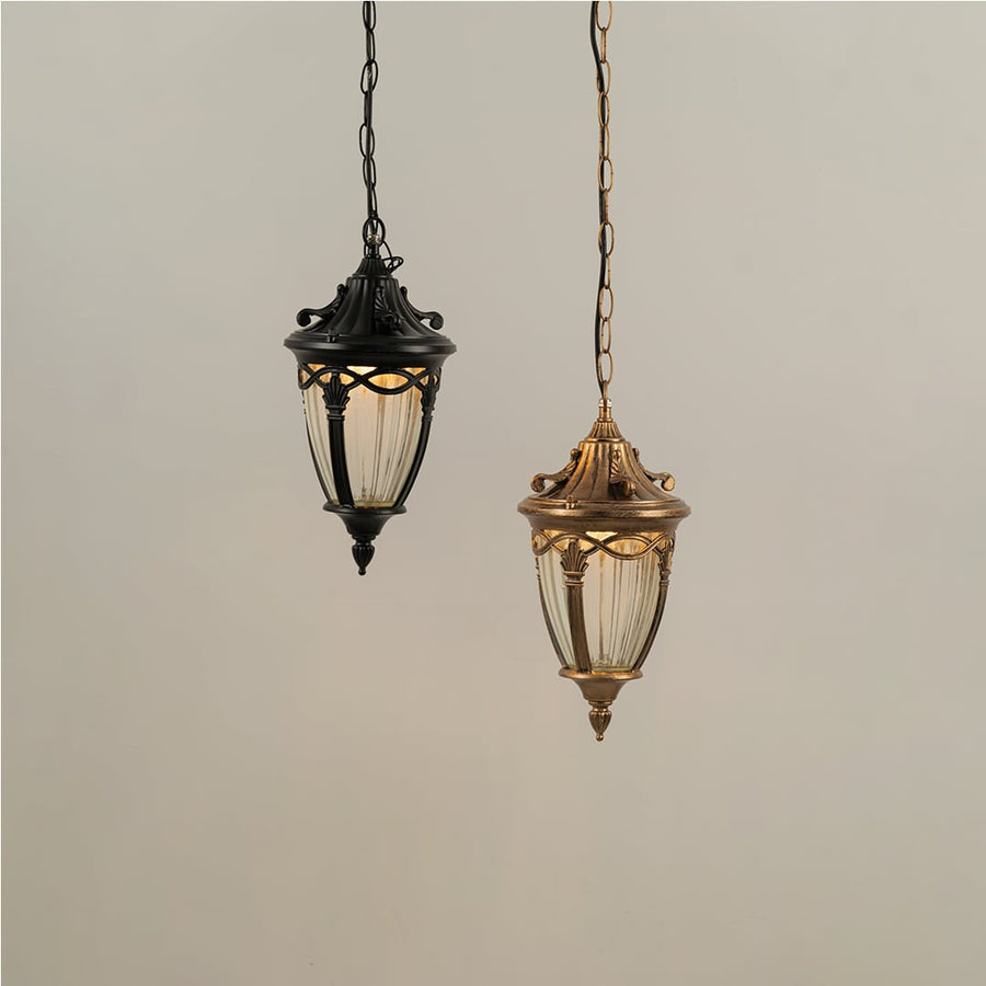 Grouped display of antique gold metal lanterns with lights off showcasing elegant outdoor lighting design.